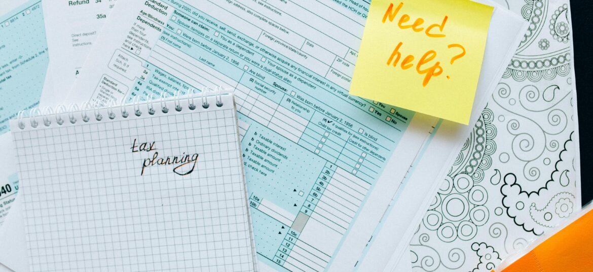 Tax documents and a note suggest tax planning and assistance needs.