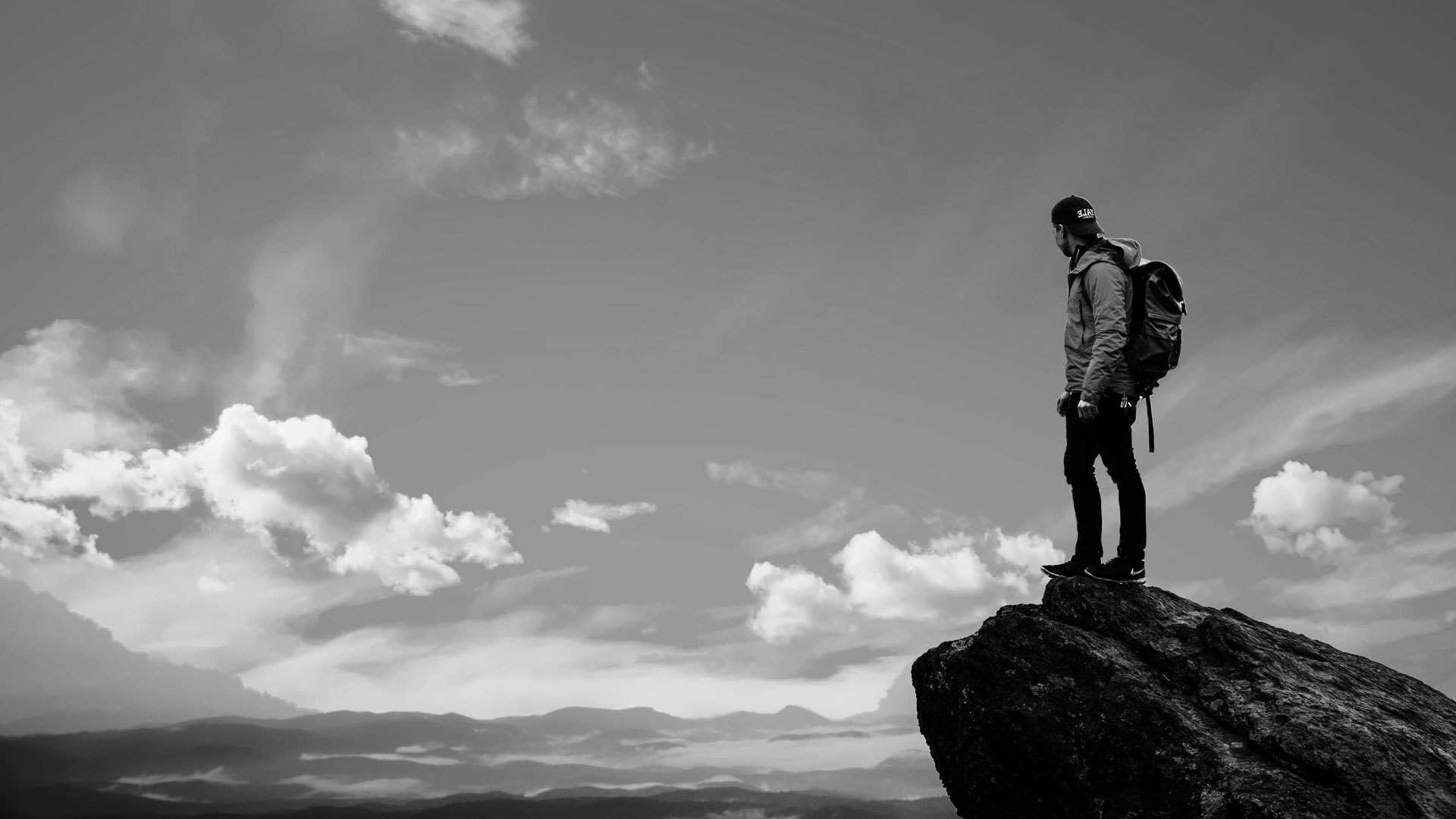 A man standing on top of a rock.